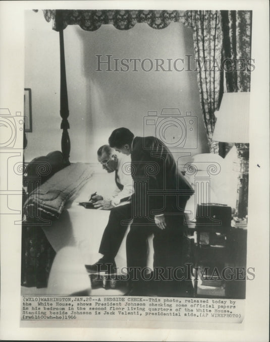 1966 President Johnson checked official papers in his bedroom. - Historic Images
