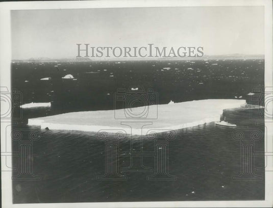 1957 Press Photo U.S. Westwind seen beside the three-quarters of a mile iceberg. - Historic Images