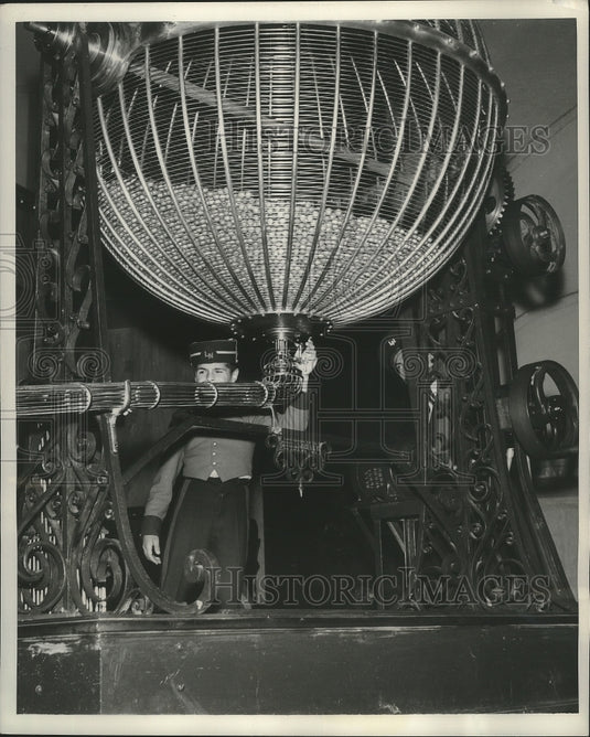 1953 Page boy releases number from chute for the lottery - Historic Images