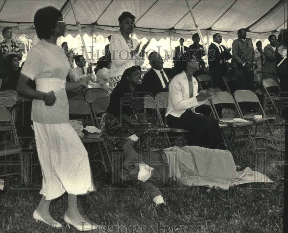 1992 Press Photo Woman falls to the ground with emotion during church service- Historic Images