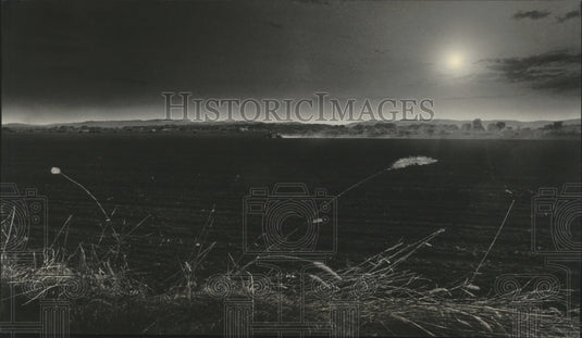 1985 A Crawford County farmer races the setting sun in Wisconsin - Historic Images
