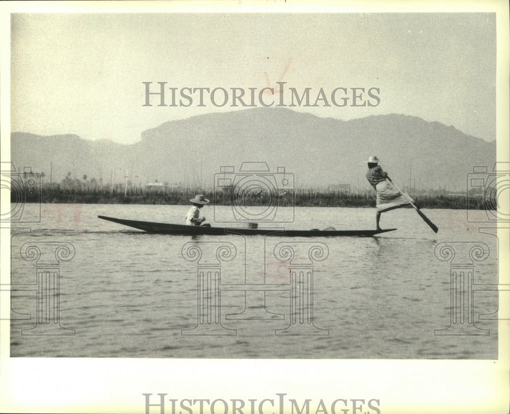 1983 Boatmen Propel Craft By Wrapping A Leg Around Oar In Burma - Historic Images