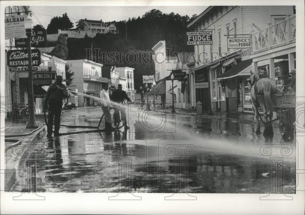 1966 Men hosing down street on Mackinac Island-Historic Images