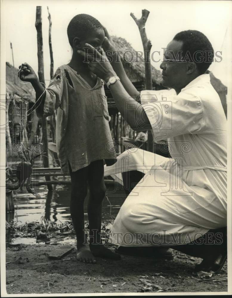 1962 Dr. Roger Akouete Examines Young Boy&#39;s Eyes in Africa-Historic Images