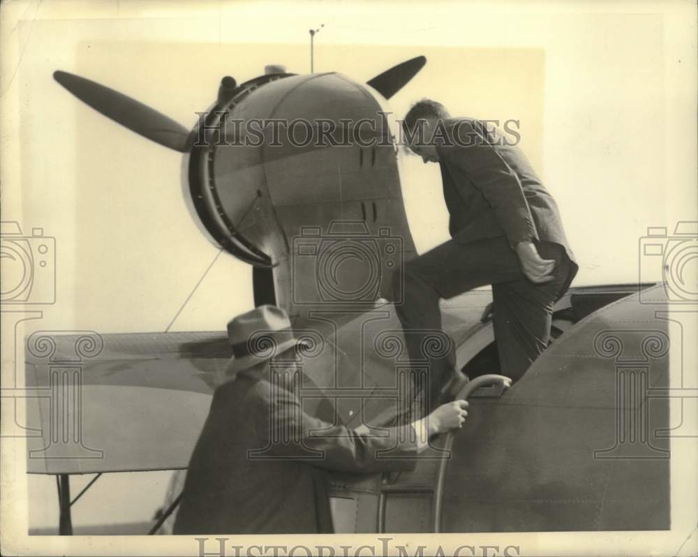 1935 Charles Lindbergh inspecting a plane in Trenton, New Jersey - Historic Images