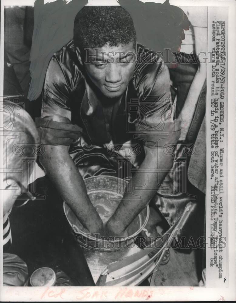 1957 Press Photo Heavyweight Champion Floyd Patterson soaks his hands in water. - Historic Images