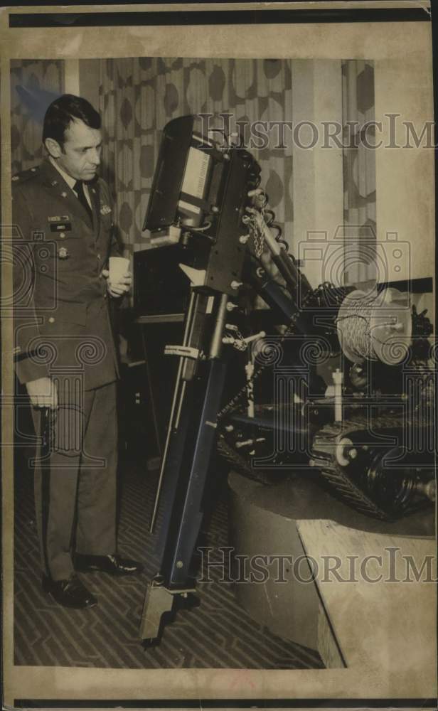 1975 Army officer inspects Wheelbarrow Mark VII, a bomb disarm robot - Historic Images