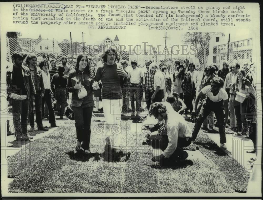 1969 Berkeley demonstrators on grassy sod in middle of Haste street - Historic Images