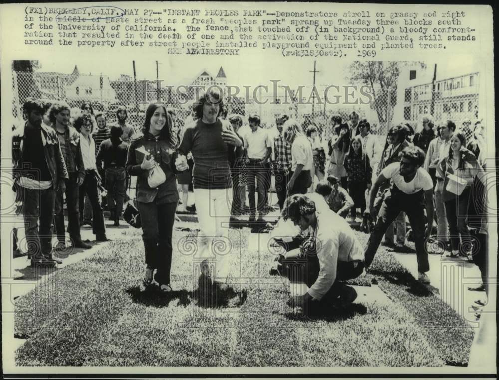 1969 Berkeley demonstrators on grassy sod in middle of Haste street - Historic Images