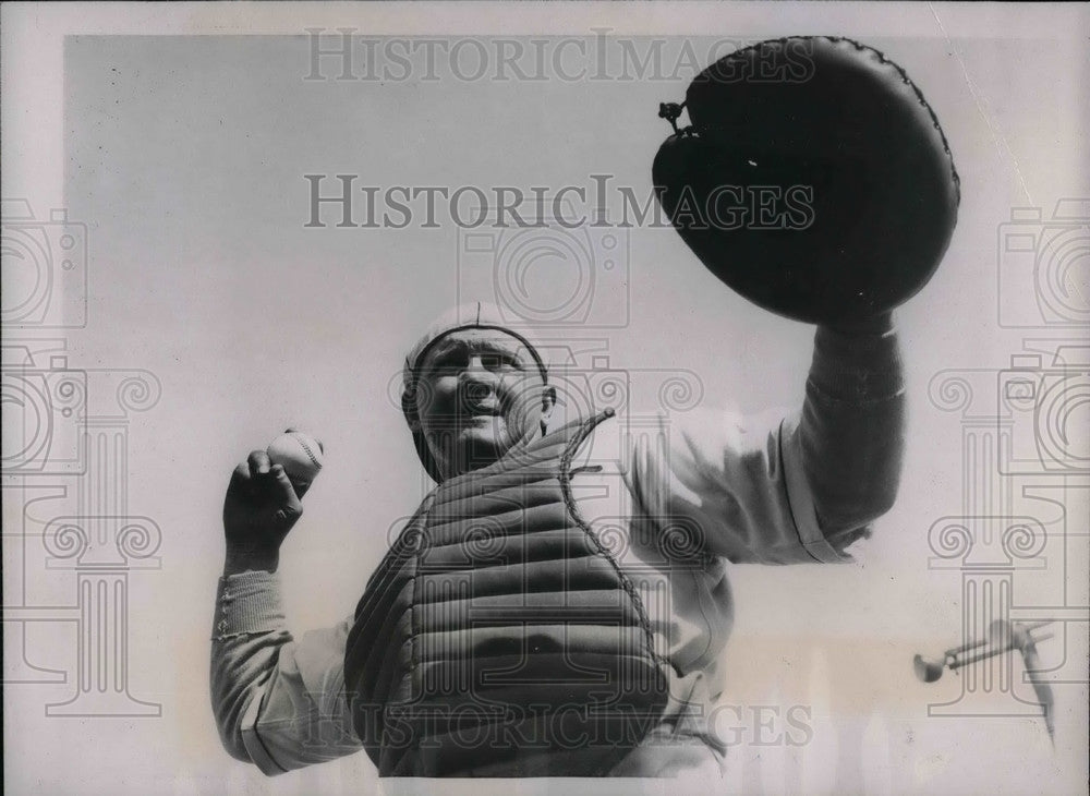 Umpire Catches and throws back ball to baseball players - Historic Images