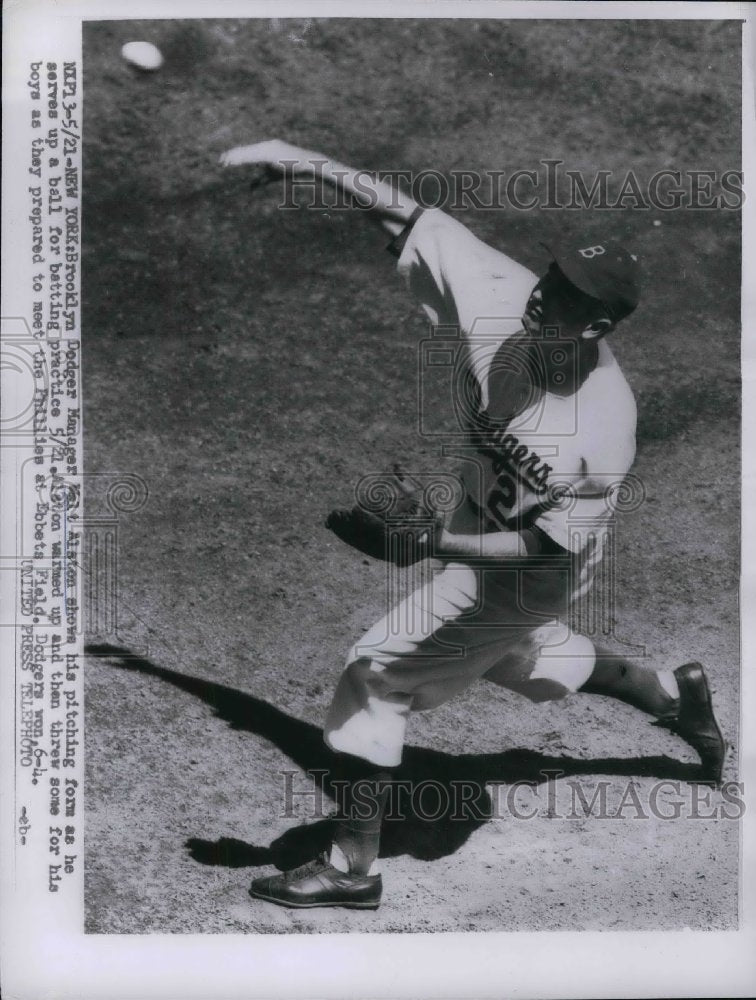 1955 Manager Walt Alston shows hit pitching form - Historic Images