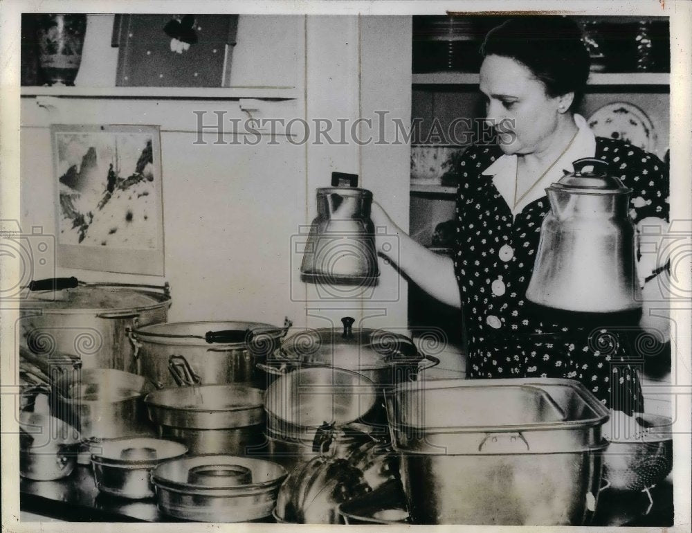 1941 Mrs. Clarence Dystra, selecting Aluminum Utencils for OPM . - Historic Images