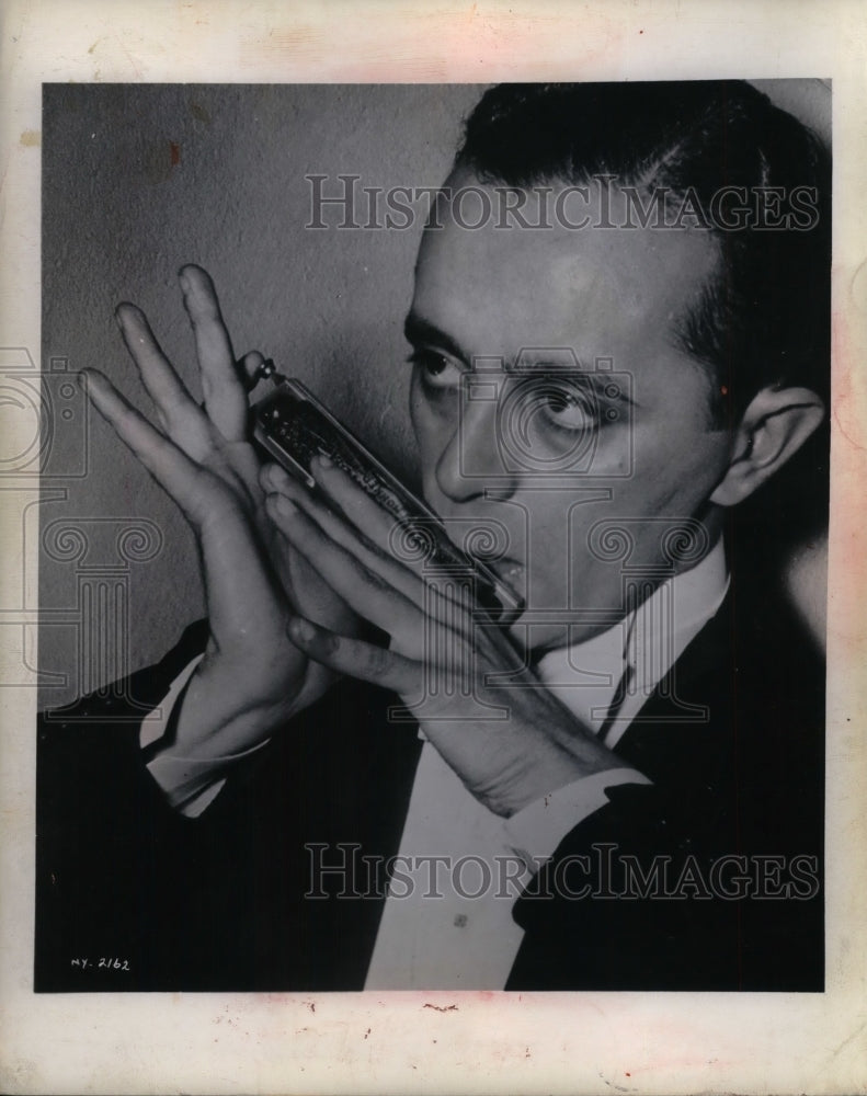 1947 Musician Larry Adler &amp; a harmonica - Historic Images