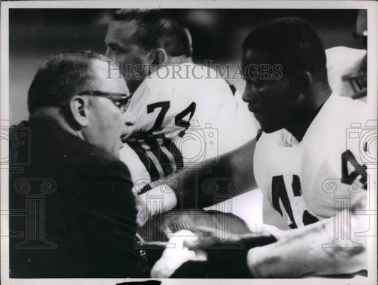 1964 Football PLayers on field getting a speech  - Historic Images