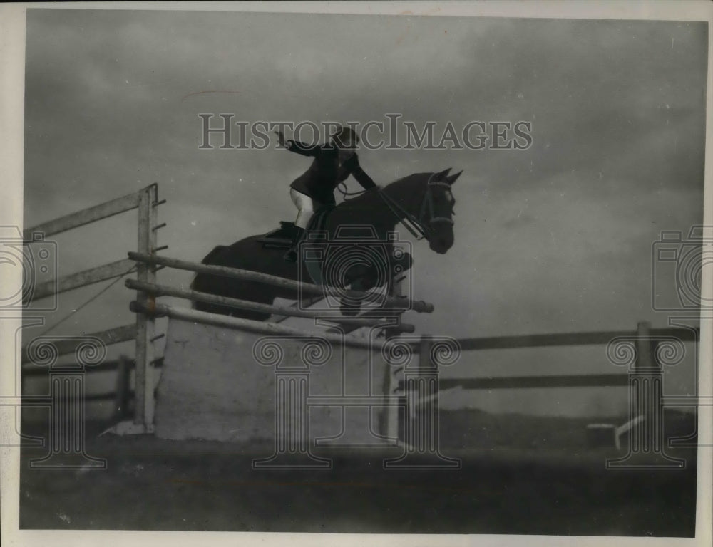 1941 Man on a horse going over a jump in competition  - Historic Images