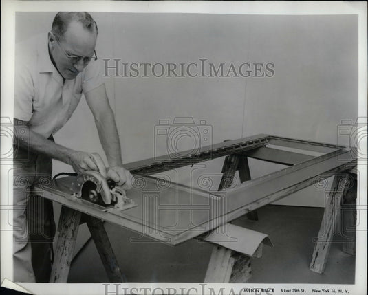 1962 Press Photo Aluminum Door Sawed to Proper Height - nea22900 - Historic Images