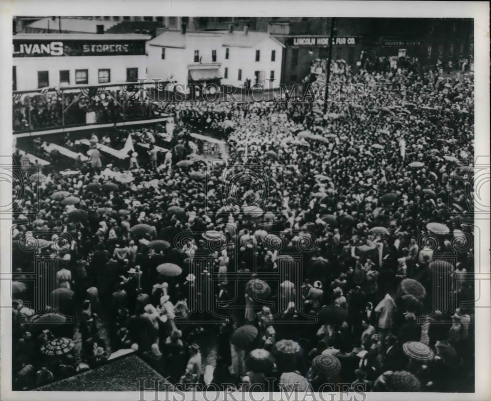 1950 People stand in the rain to listen to Pres. Truman Speech. - Historic Images