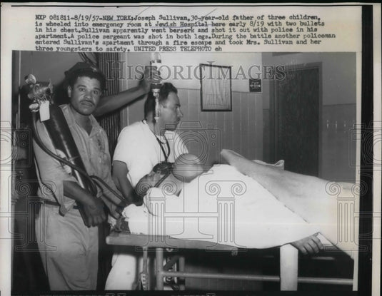 1957 Press Photo Joseph Sullivan father of 3 children being brought to the-Historic Images