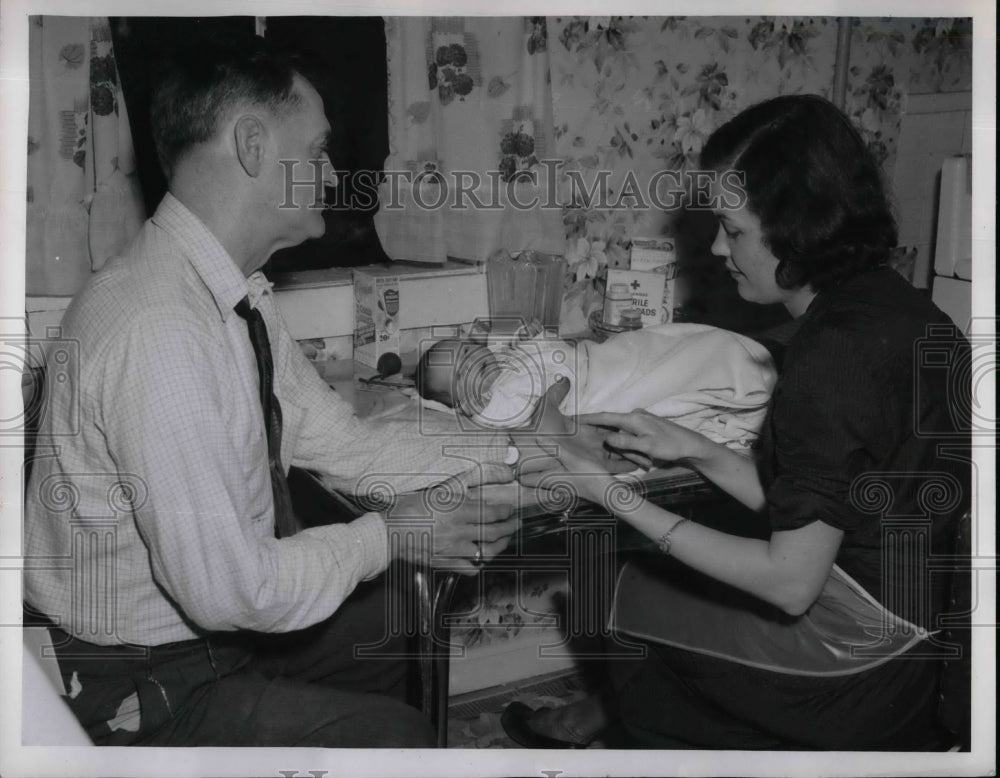 1955 Nurse Marilyn Miller gives instructions to Harold Hathaway on - Historic Images