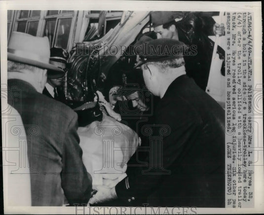 1949 Mrs. L. S. Hayes carried from wrecked trolley in Atlanta - Historic Images