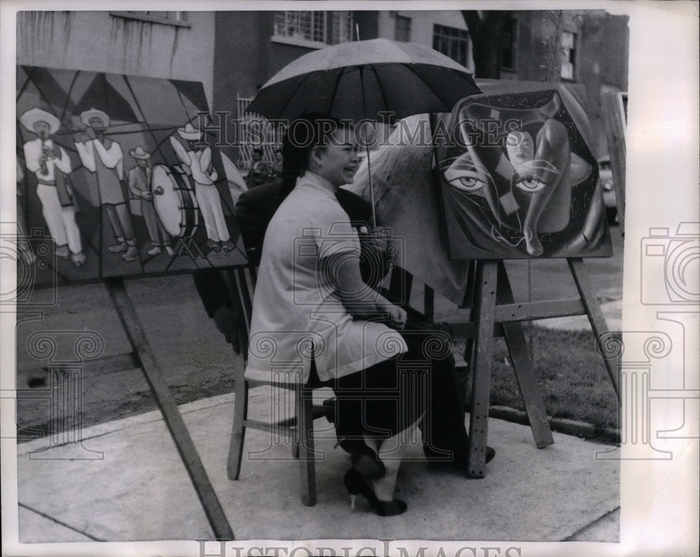 1957 Press Photo Luis Vizuet sitting as a model for a picture by Tita Vizuet. - Historic Images