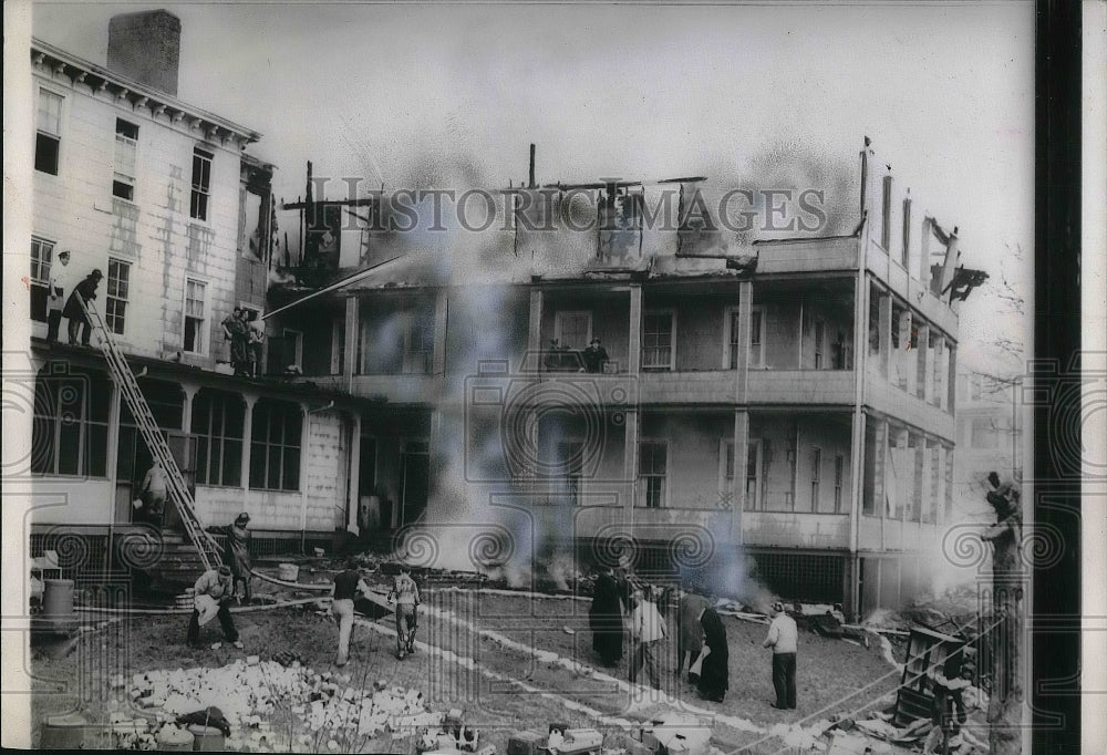 1953 Firemen spray water through St.Joseph Home for Boys. - Historic Images