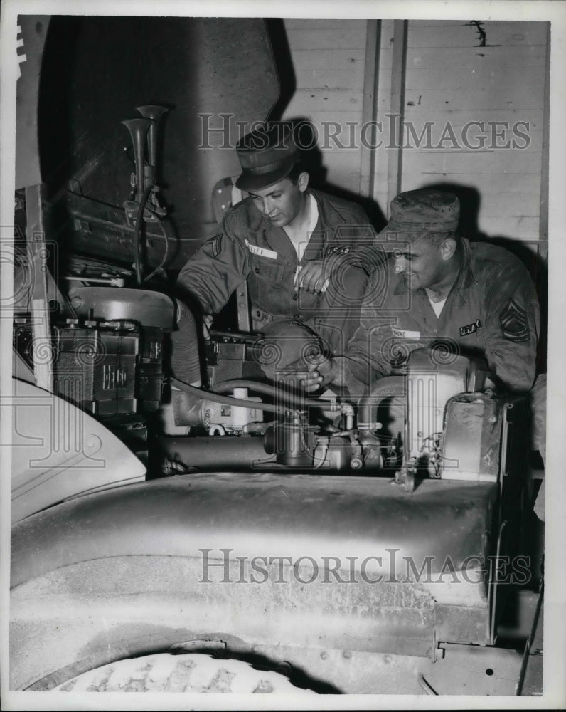 1955 Cpl. Gene Lilly and Vincent Vasko looking at engine - Historic Images