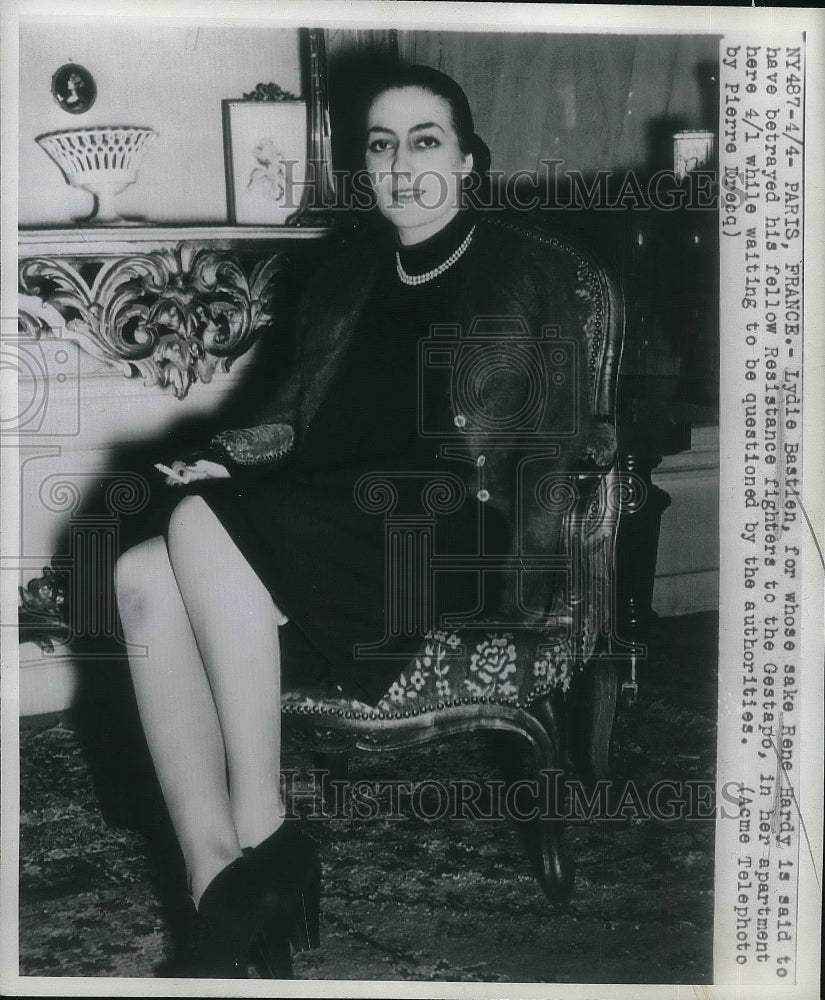 1947 Lydie Bastien at her Paris home awaits questioning - Historic Images