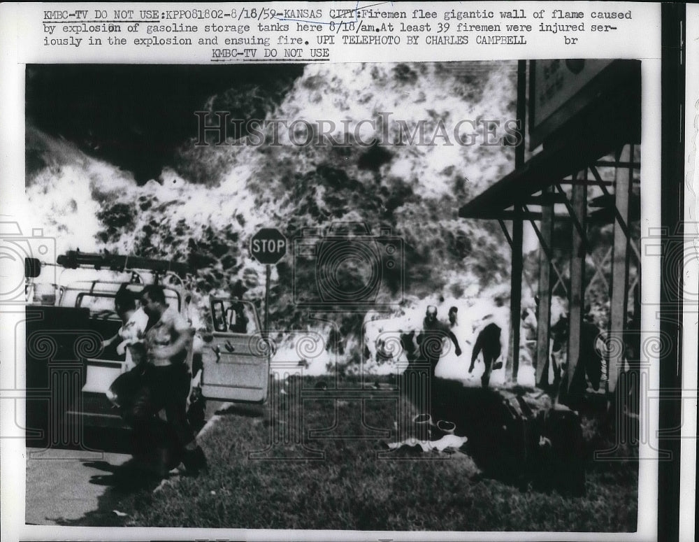 1959 Press Photo Firemen run in a Gigantic Flame explosion of gasoline in Kansas-Historic Images