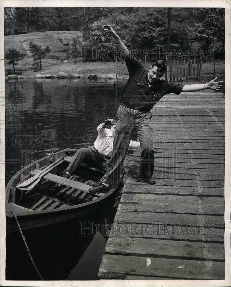 1951 Two Men Illustrate Wrong Way To Enter Boat In Water Near Dock - Historic Images