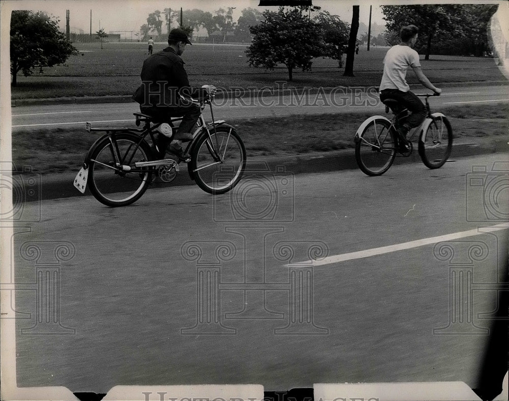 1951 Press Photo Two Men Ride Bikes Down Street - nea41900 - Historic Images