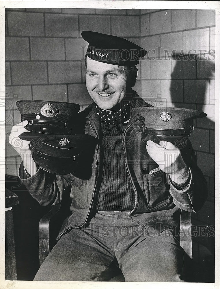 1942 Press Photo Walter Urbaneo Models With Hats Of Jobs He Has Held - nea46392 - Historic Images