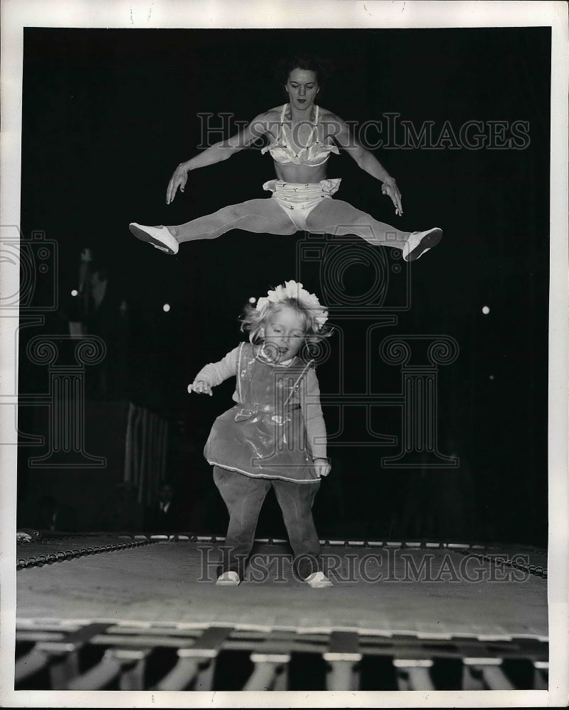 1947 Betty Bell high jinks while romping with her baby Nikki. - Historic Images
