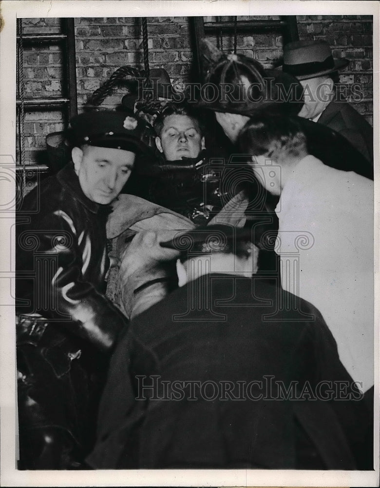 1947 Press Photo Rescue workers lowering Harold Lawler to the Ground - nea50669 - Historic Images