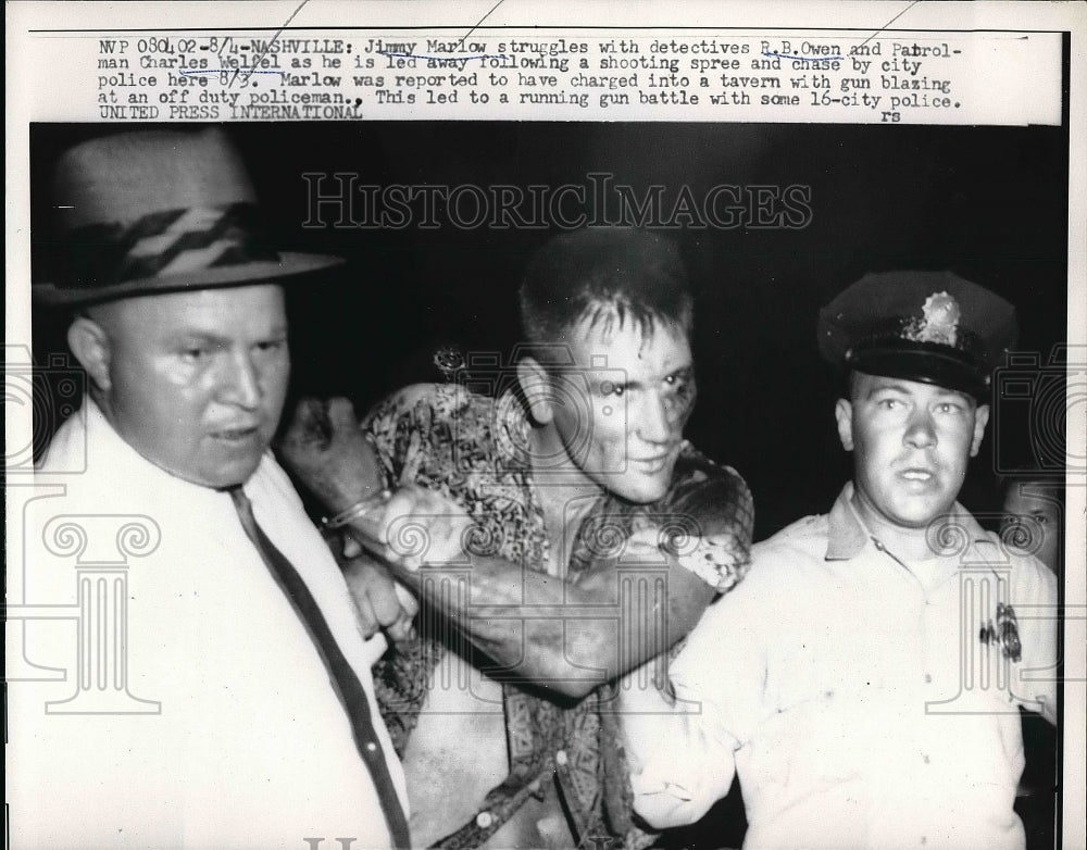 1959 Jimmy Marlow held by police for gun blazing at duty policeman. - Historic Images