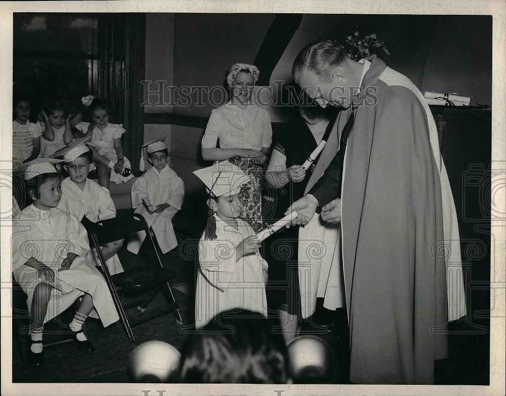 1948 teacher handing out diplomas at a graduation  - Historic Images