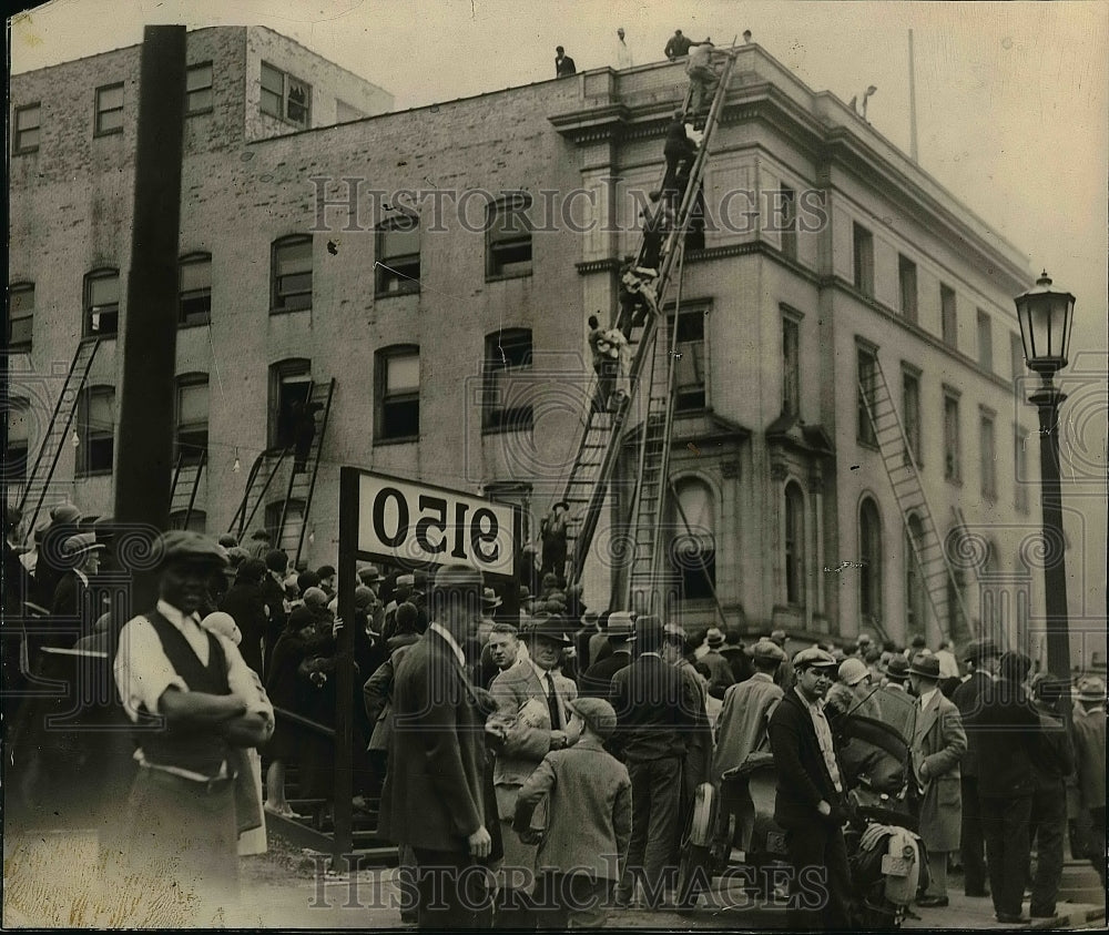 Press Photo Crowd watches firemen at work on burning building - nea51660 - Historic Images
