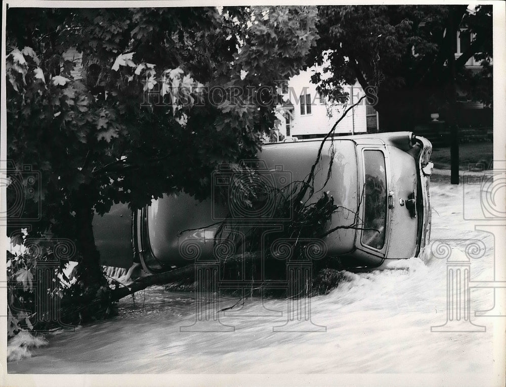 1959 Car overturned by flood waters on Meadowbrook in CH  - Historic Images