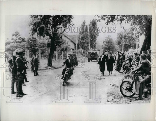1961 Biker playing chicken within inches of the East German boarder. - Historic Images