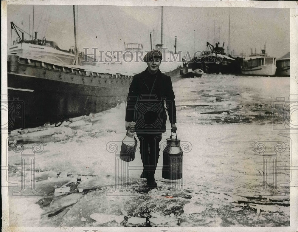 1933 German tanker stuck in ice as the skipper walks on the ice. - Historic Images