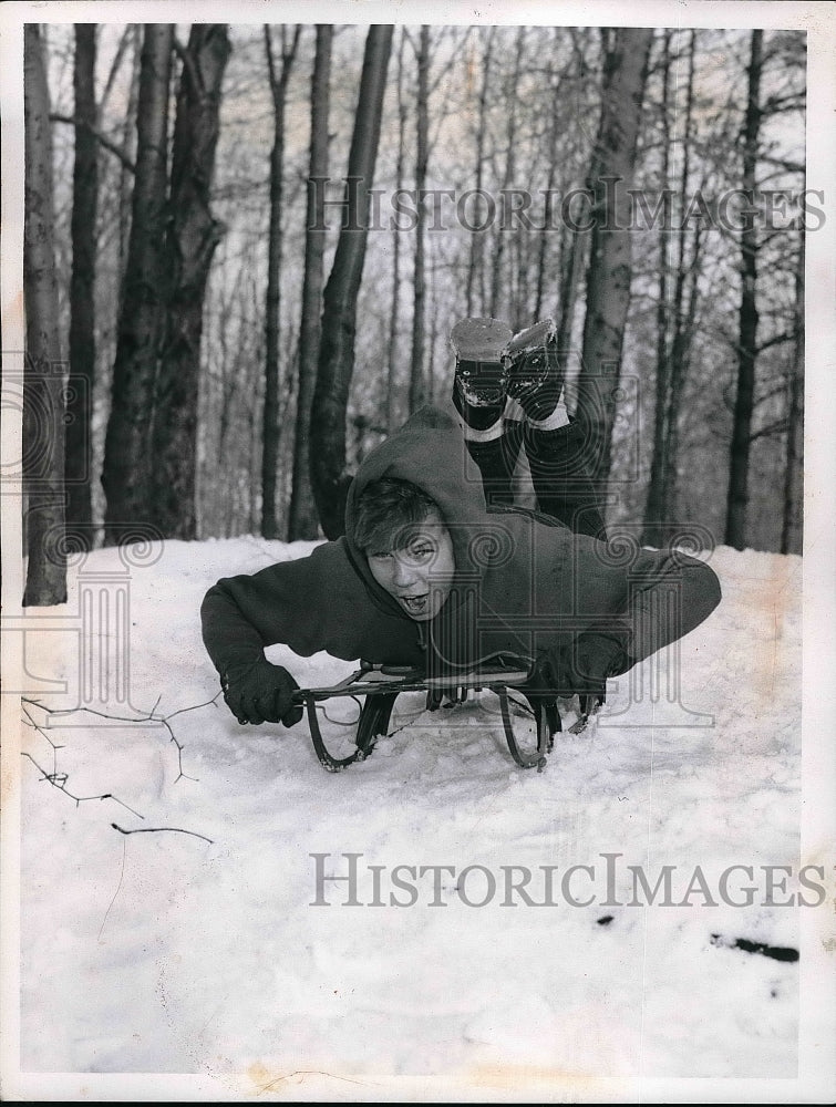 1958 Press Photo Larry Budzowski sledding down a hill - nea52133 - Historic Images