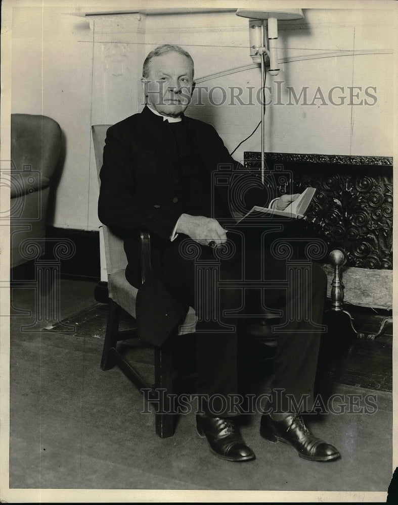 1930 Rev. James Perry Sitting In Chair Holding Book  - Historic Images