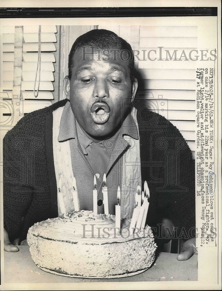 1962 Press Photo Sugar Ray Robinson Blows Out Candles Marking 22 Fighter Years - Historic Images