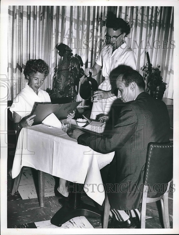 1959 Two people sitting down at restaurant table  - Historic Images