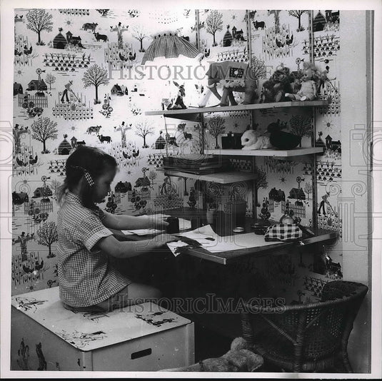 1954 Press Photo Young girl working at a wall hung desk - nea55848 - Historic Images