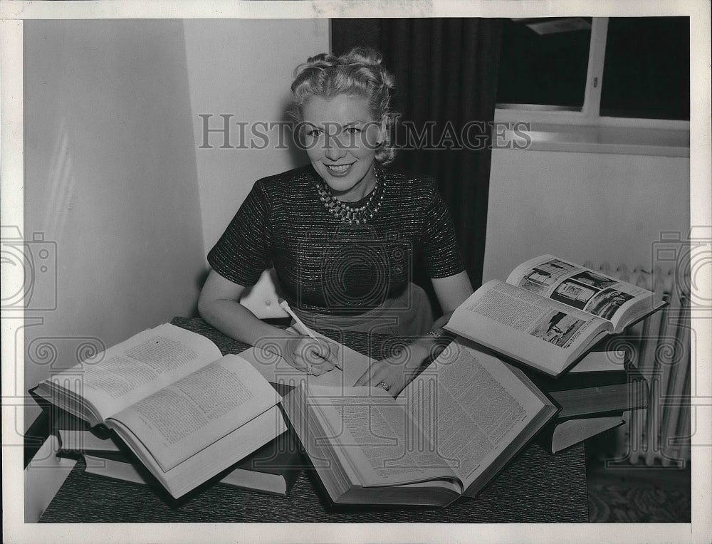 1953 Press Photo Woman sitting at a desk with books open - nea56025-Historic Images