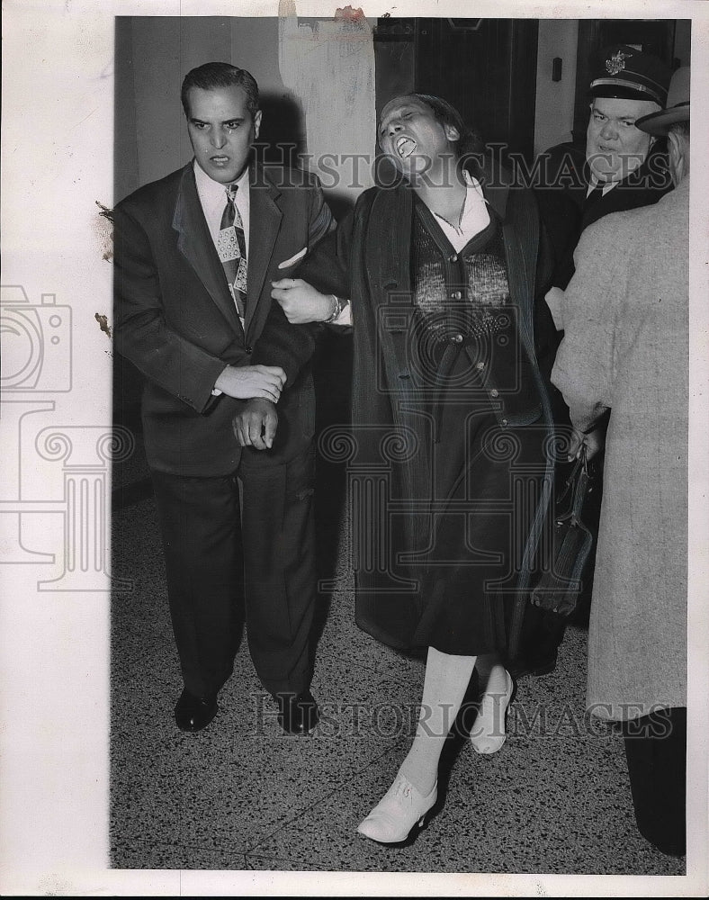 1954 Woman being escorted away from trial  - Historic Images