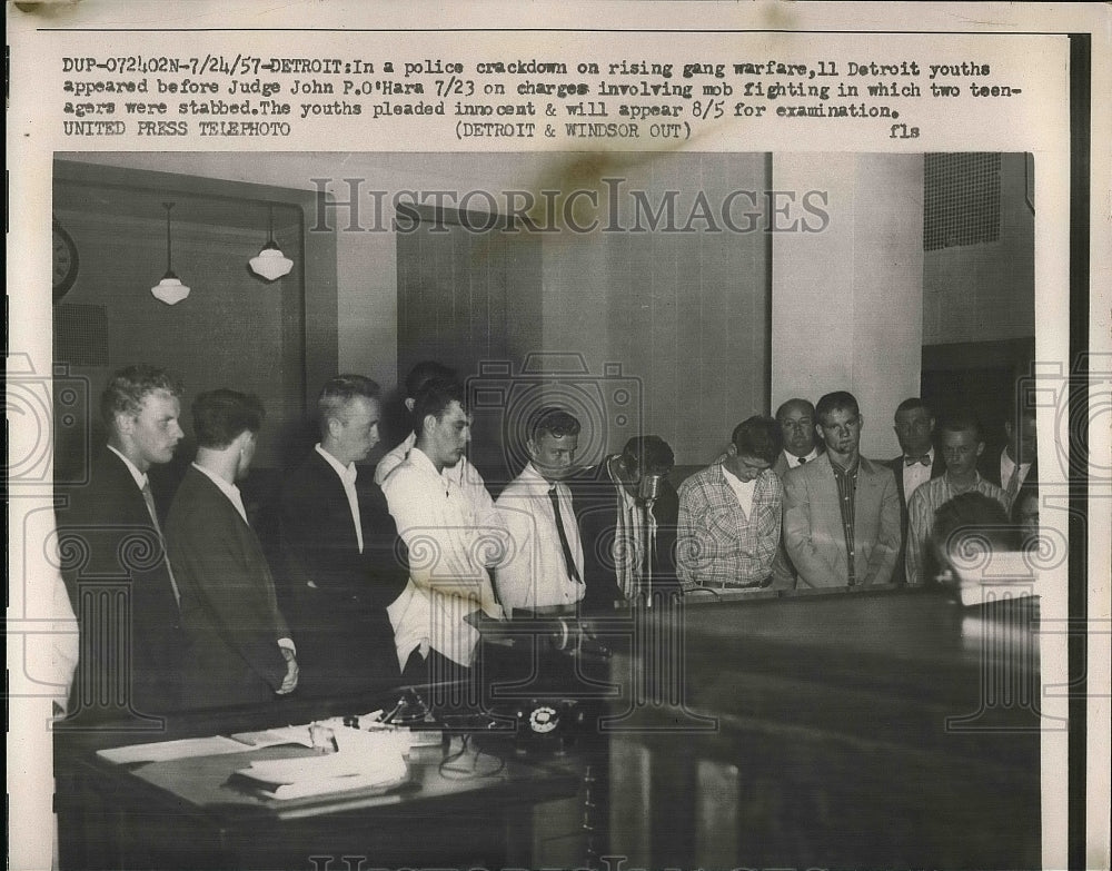 1957 11 youthful gang members stand before a judge.  - Historic Images