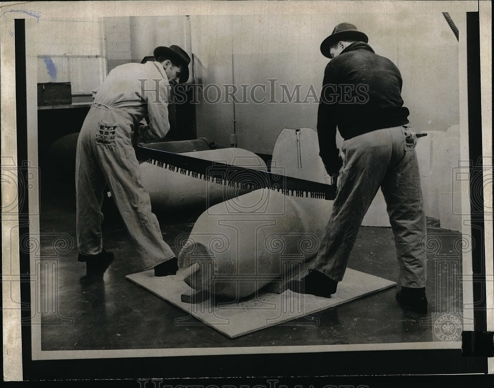 1943 Press Photo Two workers cutting through bombs - nea56705 - Historic Images