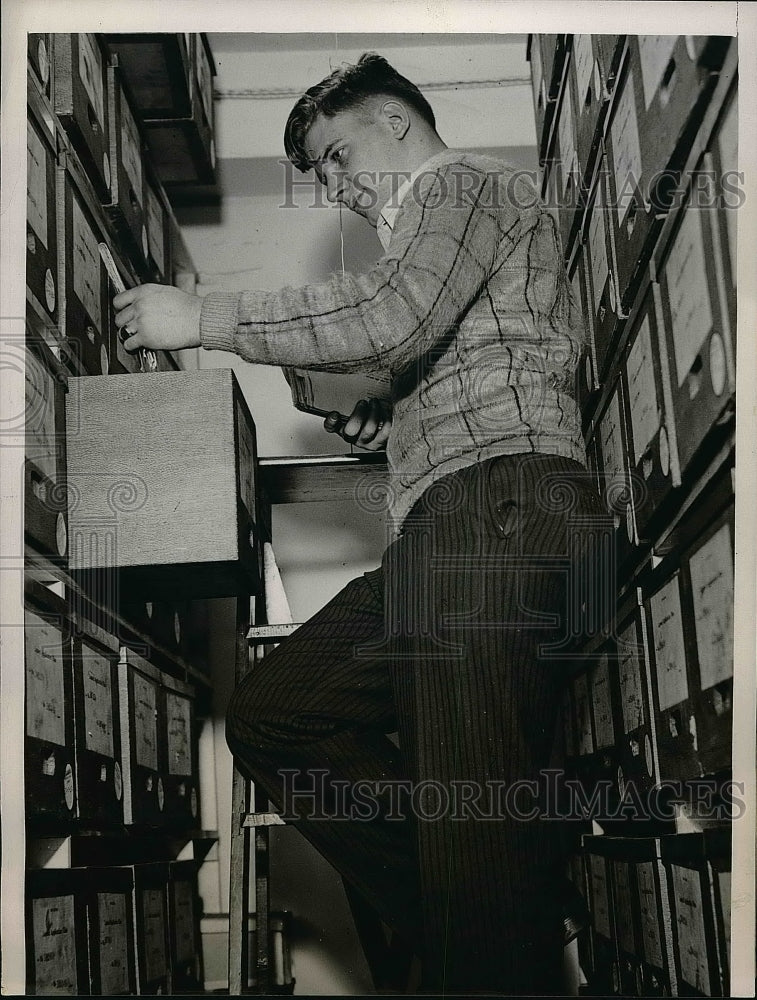 1938 Bill DeCorrevont in file room of Allstate insurance Co. - Historic Images